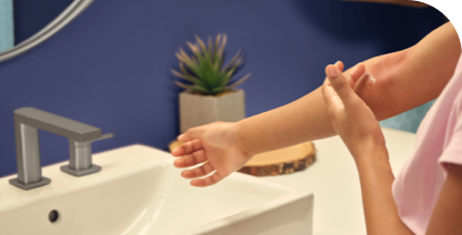  Photo of female applying OPZELURA to atopic dermatitis on the inside of her right elbow.